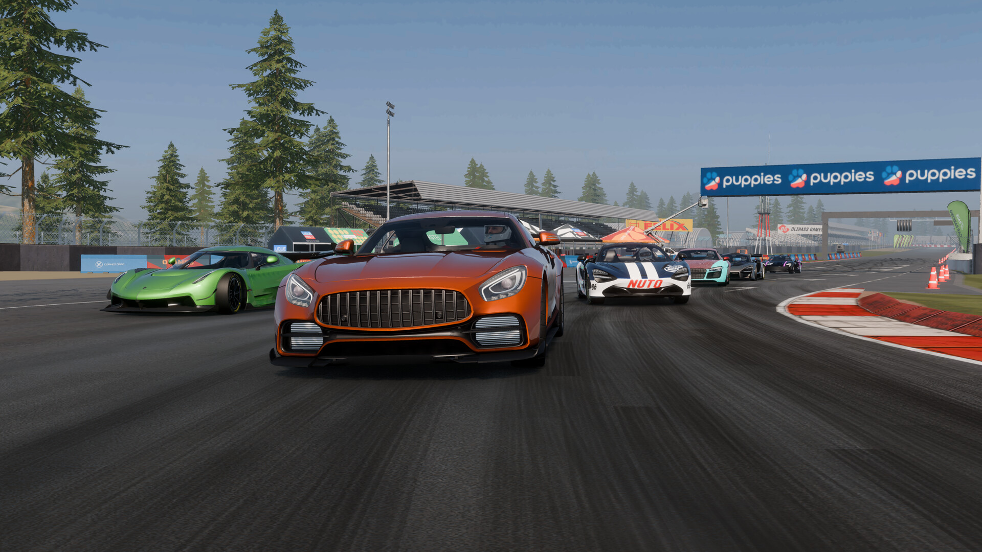 CPM 2 official Steam screenshot: an orange sports car leads a pack of racers onto a circuit straight